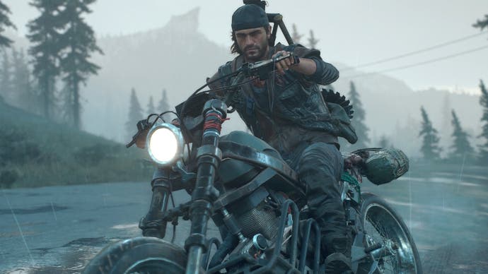 Screenshot showing Days Gone protagonist Deacon St. John riding his bike along a foggy tree-lined highway while a mountain looms in the background.