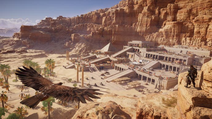 An eagle flies over the Valley of Kings in Assassin's Creed Origins.