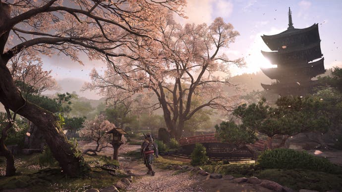 Assassin's Creed Shadows screenshot showing a temple surrounded by trees in blossom.