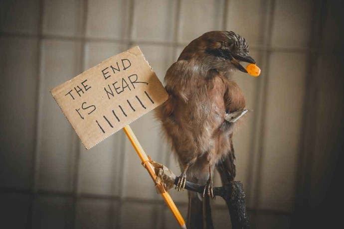 A bird holds a sign in its feet that says 