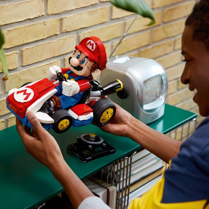 Mario Kart Lego set being placed on a stand