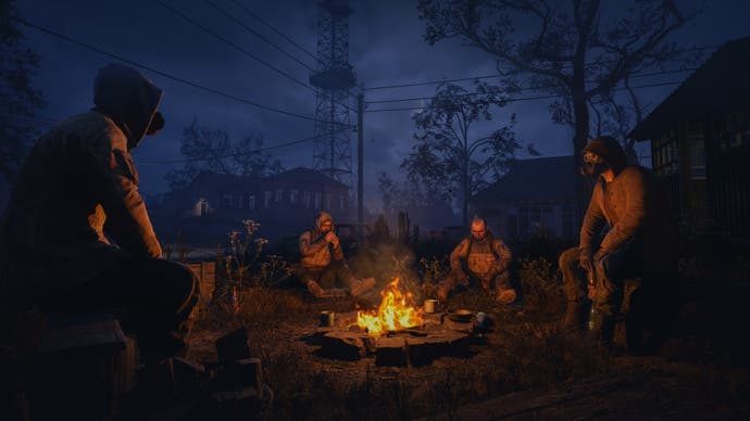 Stalkers gather around a campfire in Stalker 2.