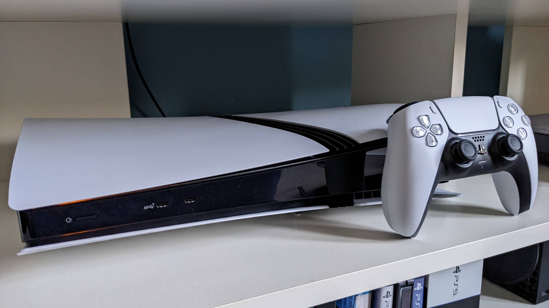A photograph of the PS5 Pro and Dualsense controller.