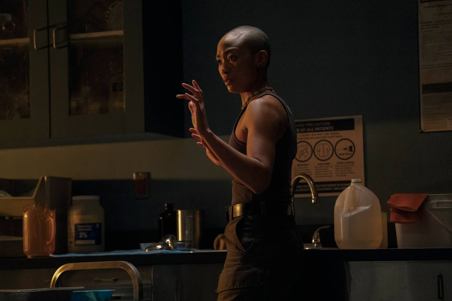 Tati Gabrielle as Nora raises her hands in The Last of Us season two
