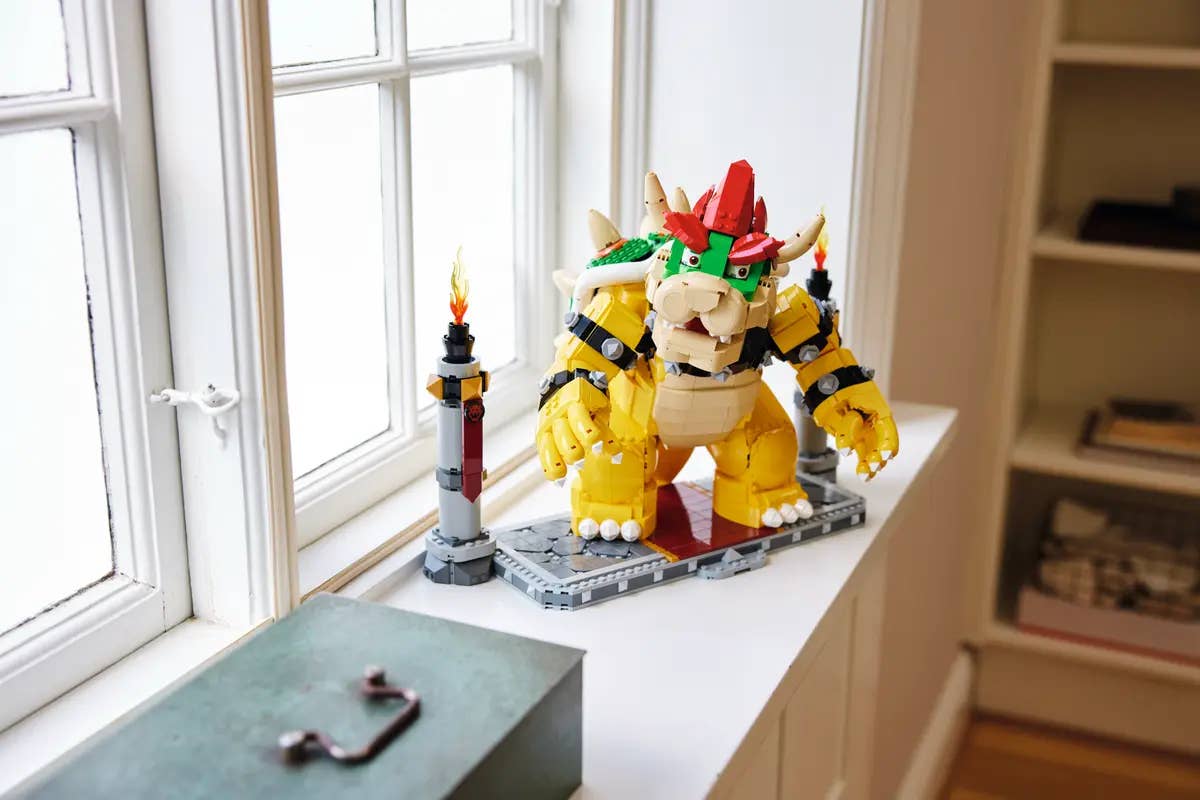 A large Bowser Lego set on a window sill. Bowser looks towards the camera with curious intensity. Perhaps he is worrying what it will be like to stand there all day in sunny weather.